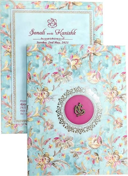 two blue and pink brochures with floral designs on the front, one has a button