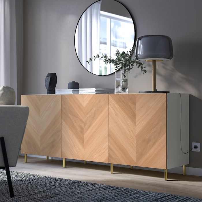 a living room with a large mirror on the wall and a wooden cabinet in front of it