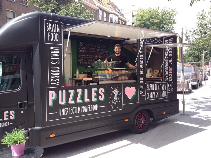 the food truck is parked on the side of the street