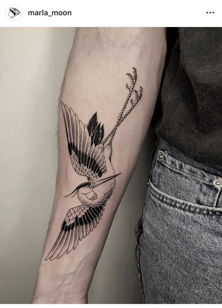 a woman's arm with a bird and arrow tattoo on the left inner arm