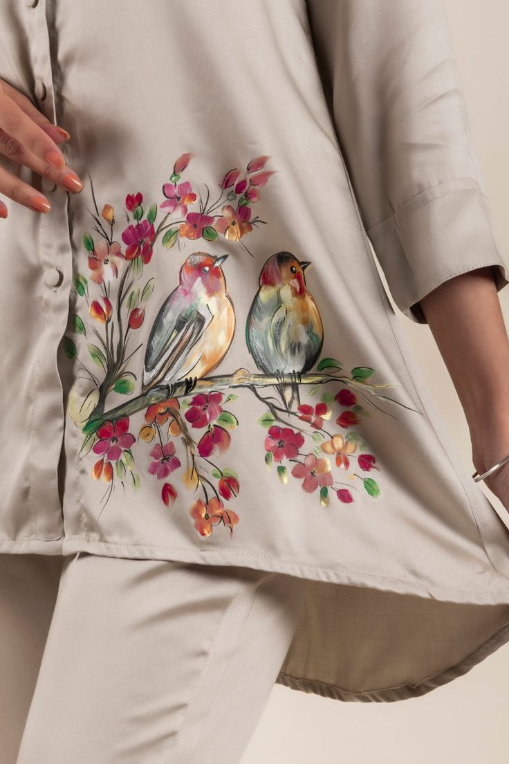 a woman is carrying a bag with birds on it