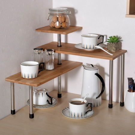 two wooden shelves with coffee cups and saucers on them, one shelf is made out of wood