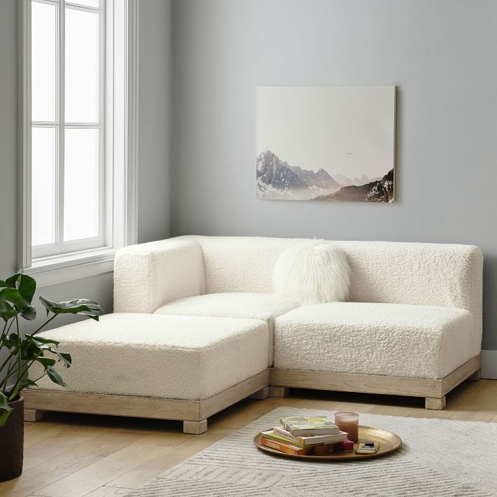 a living room with a white couch and coffee table