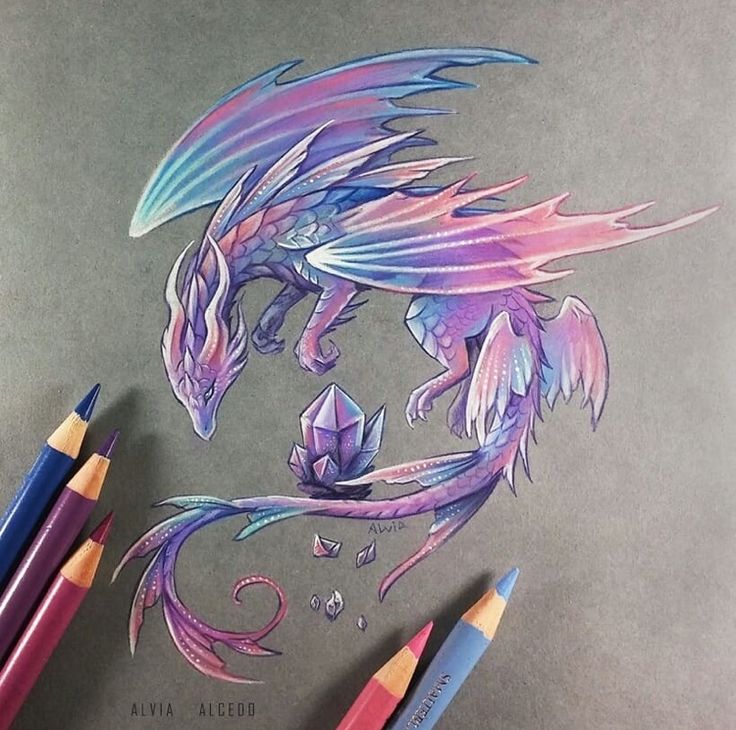 a drawing of a dragon with wings and flowers on it's head, surrounded by colored pencils