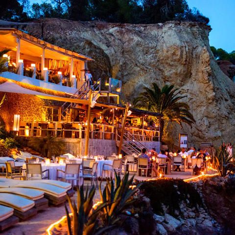 an outdoor restaurant is lit up at night