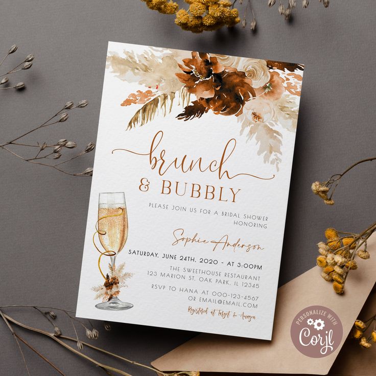 an elegant brunch and bubbly party is on display next to some dried flowers