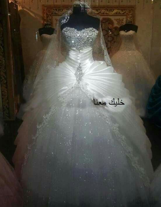 a white wedding dress on display in a store