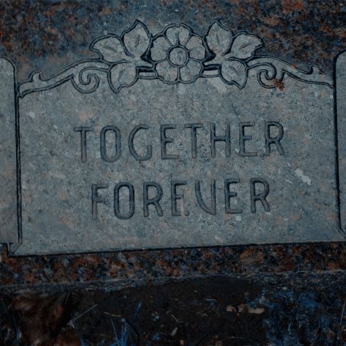 a stone sign that says together forever on it