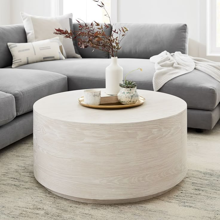 a living room with grey couches and a white coffee table