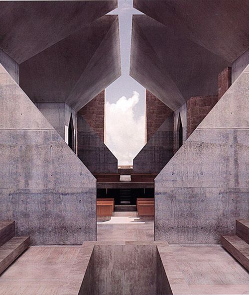 the interior of a building with concrete walls and benches