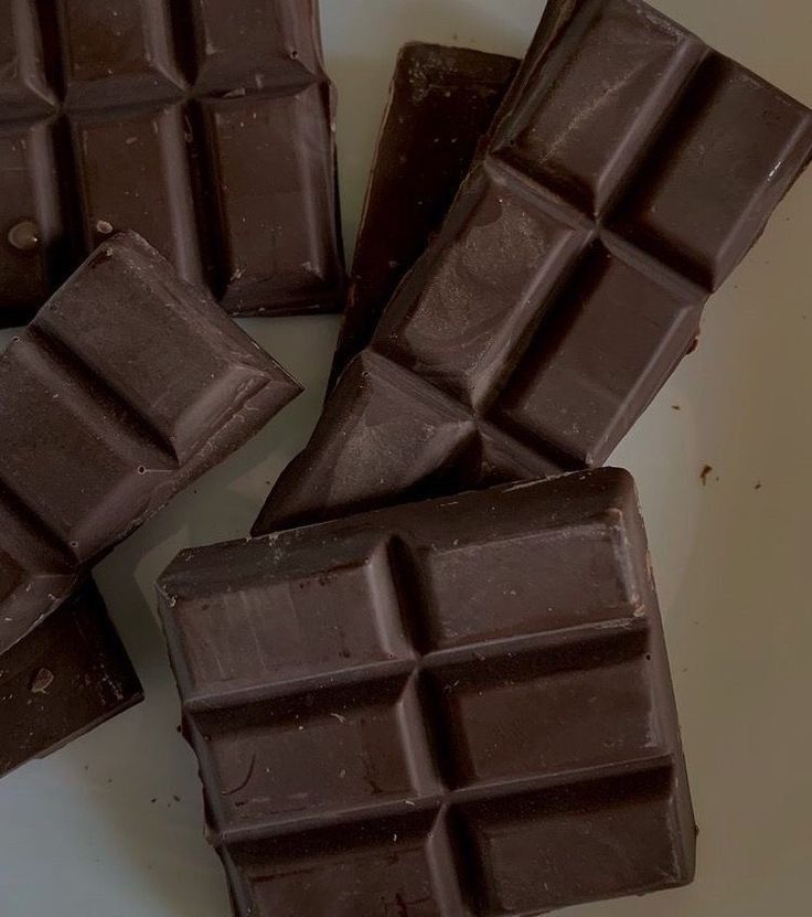 four pieces of chocolate sitting on top of a white plate