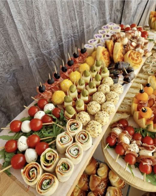 an assortment of appetizers are displayed on a table with other foods and vegetables