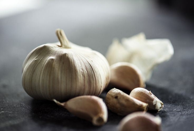 some garlic on a black counter top