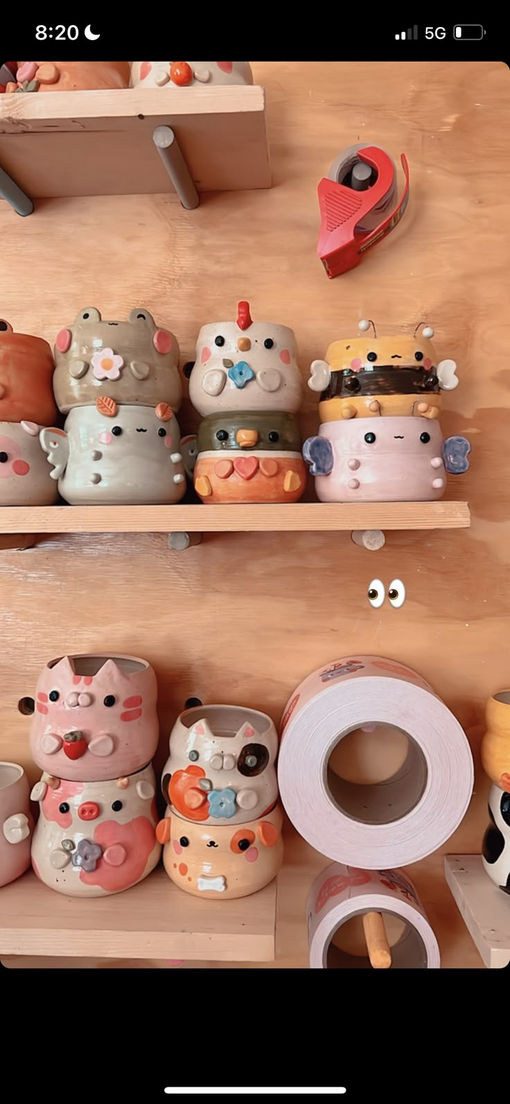 there are many ceramic objects on the shelves