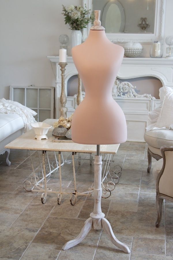 a mannequin sitting on top of a table in a room