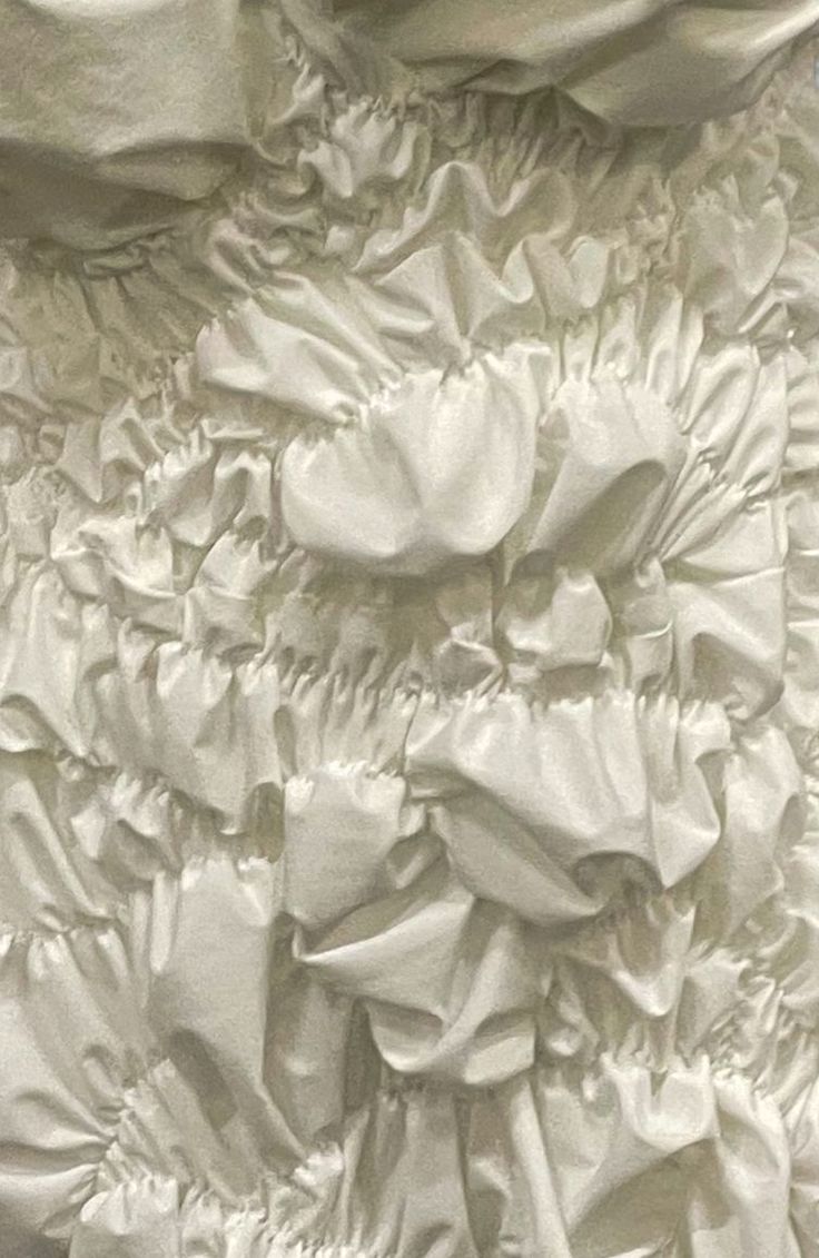 the back of a white dress with ruffles on it