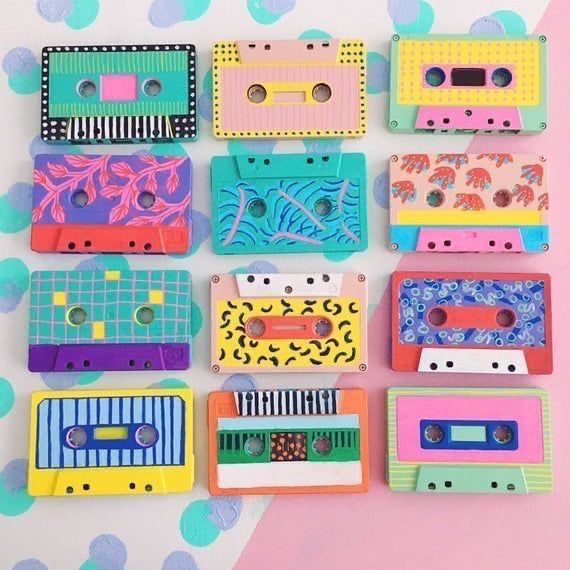 there are many different colored cassettes on the table