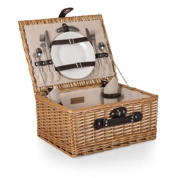 a wicker picnic basket with utensils and plates in it, on a white background