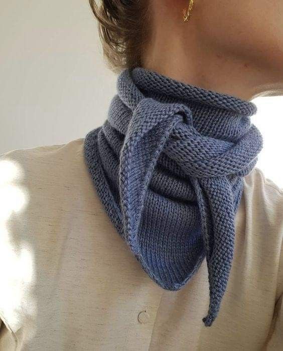 a close up of a person wearing a scarf