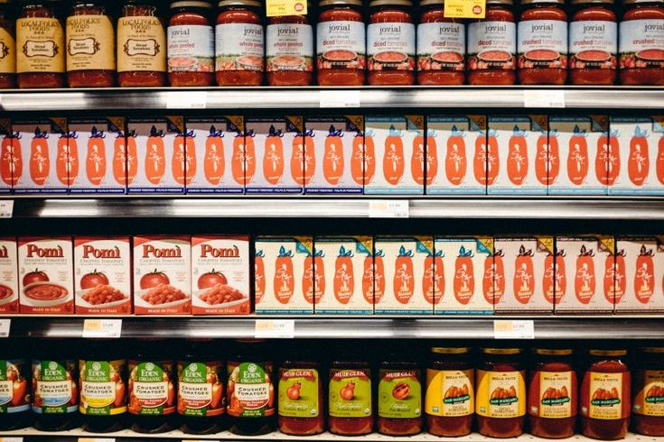 many different types of sauces on shelves in a store