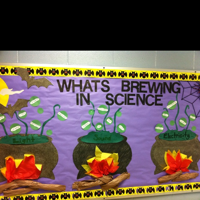 a bulletin board with paper flowers and bats on it that says what's brewing in science