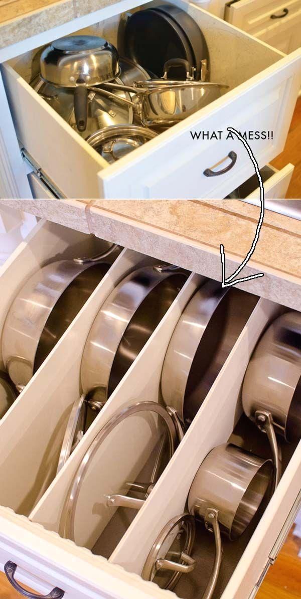 an open drawer with many pots and pans in it