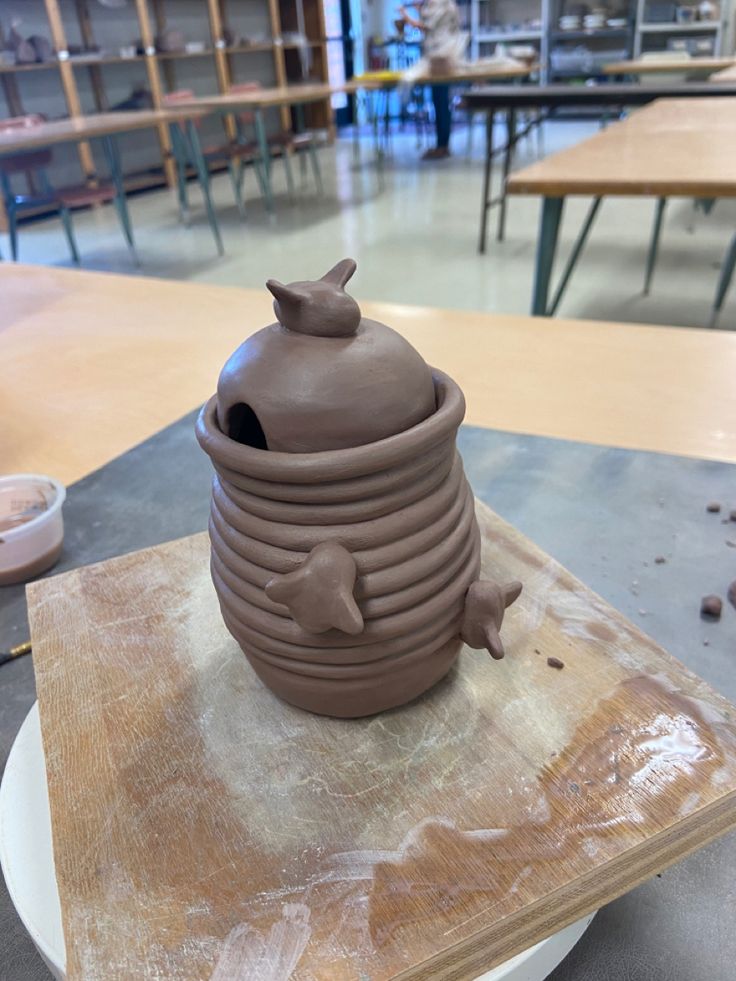 a clay pot sitting on top of a wooden table