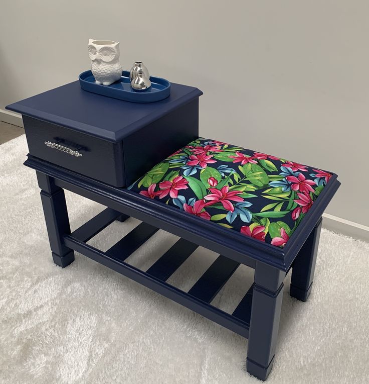 a blue table with a flowered cushion on it