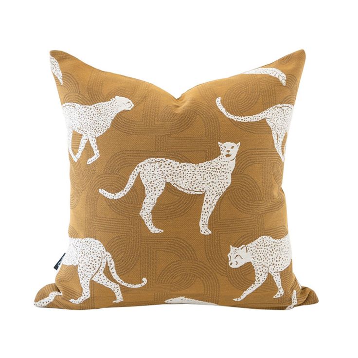 a brown pillow with white leopards on it