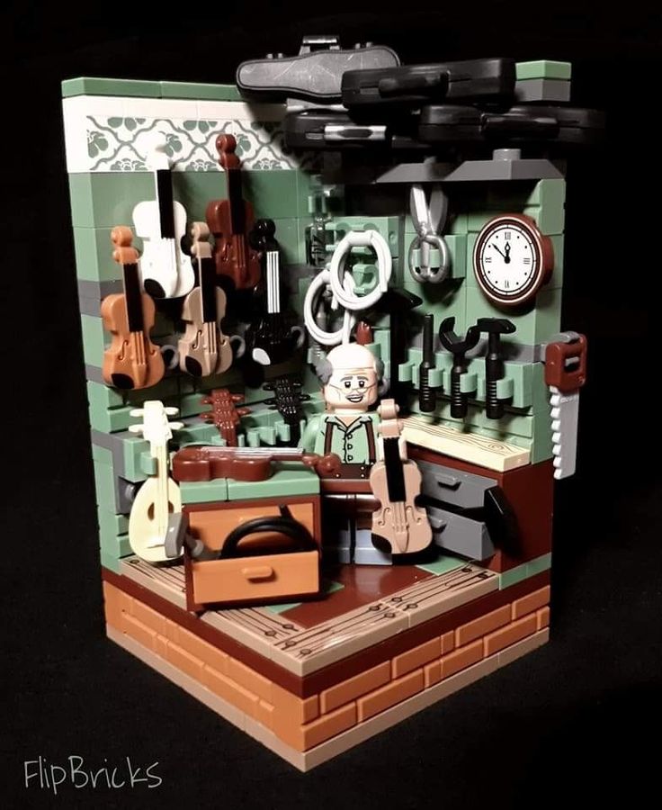 a lego model of a kitchen with various items on the counter and around it is a clock