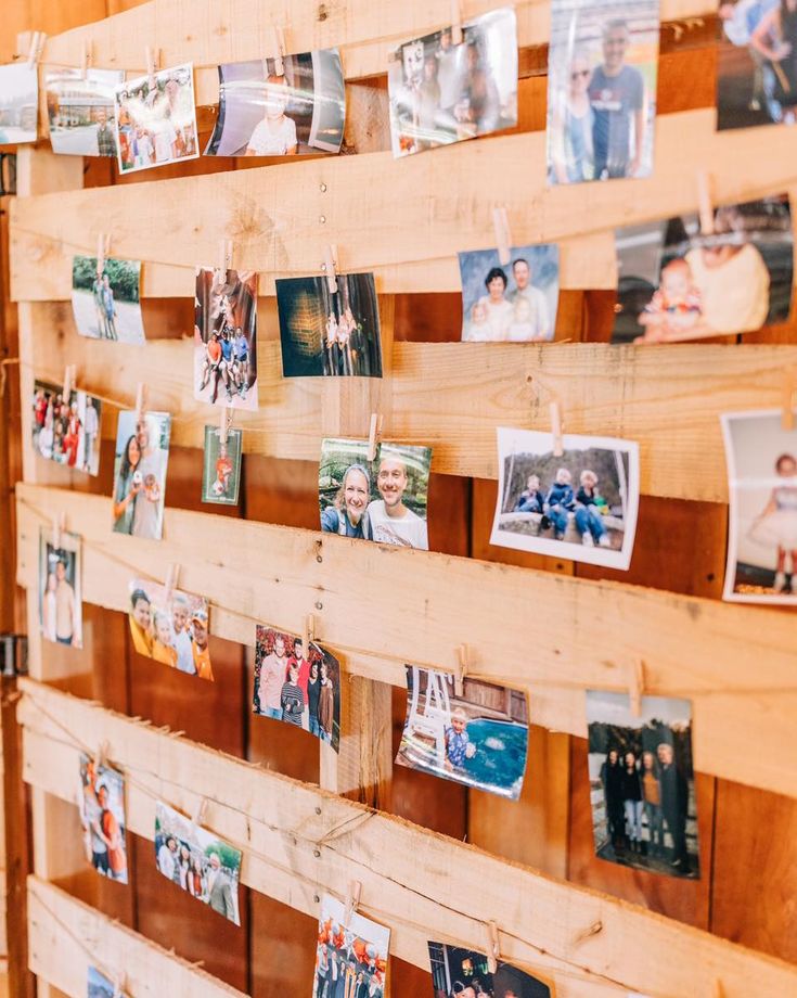 a wooden wall with pictures hanging on it and magnets attached to the wood planks