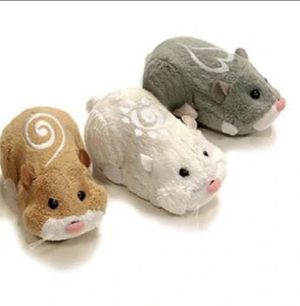 three stuffed animals sitting next to each other on a white surface with one mouse in the middle