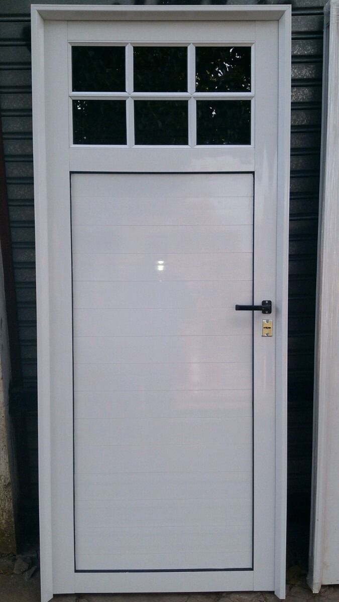 a white garage door sitting next to a building