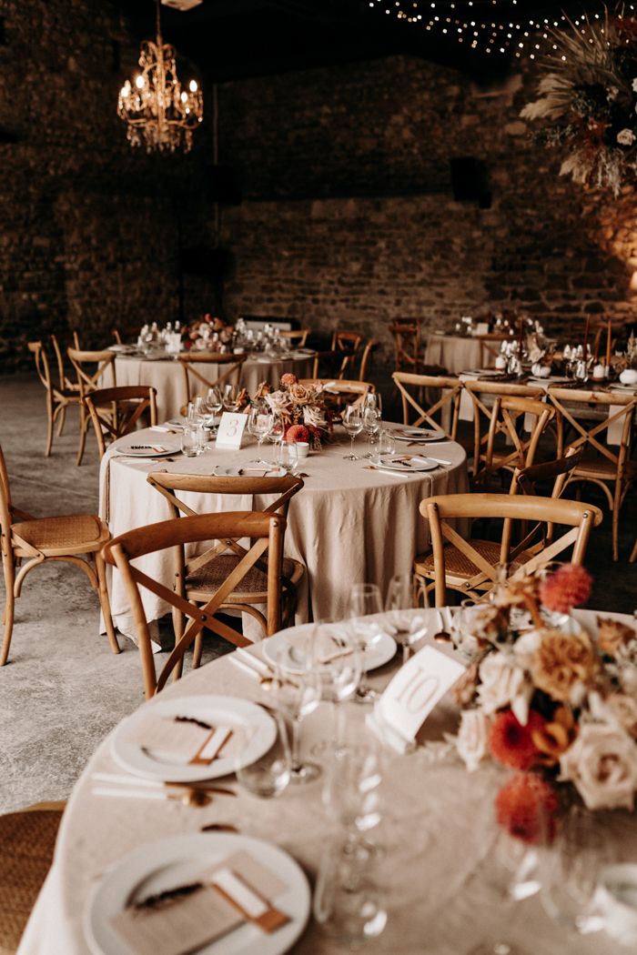 the tables are set with white linens and place settings