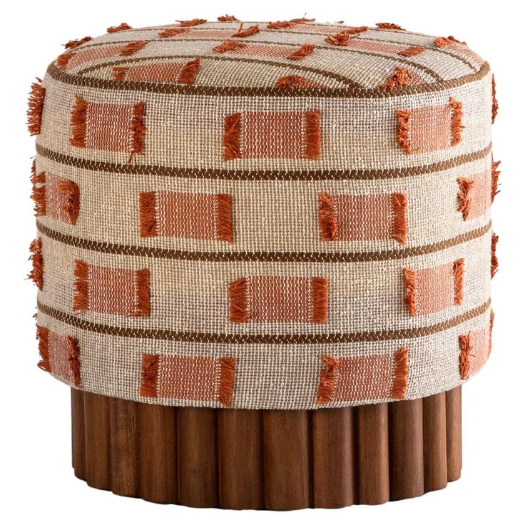 a small stool made out of wood sticks with orange and white designs on it's sides