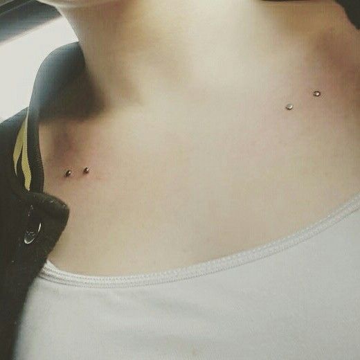 a woman with two piercings on her chest