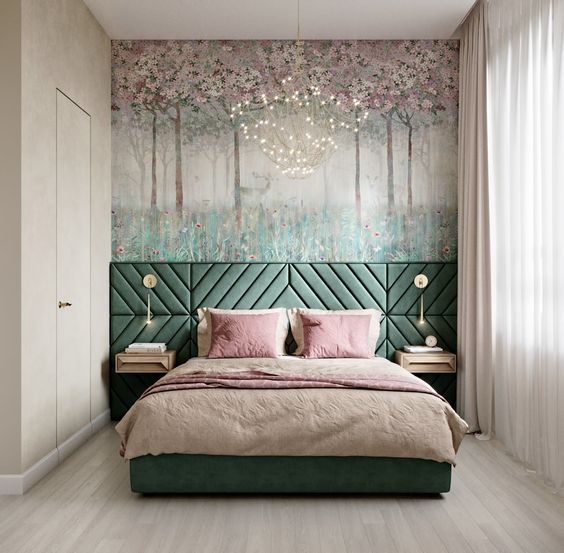 a bedroom with a green headboard and pink pillows on the bed in front of a painting