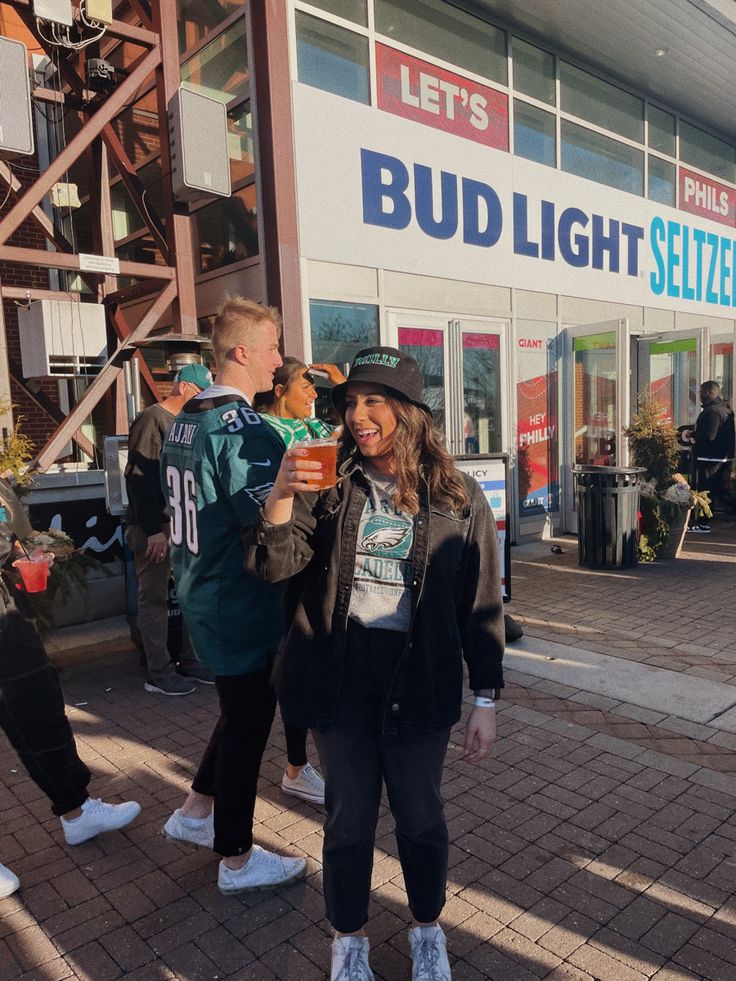 two people standing in front of a bud light store