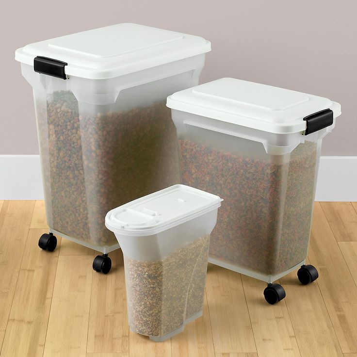 three bins with wheels are sitting on the floor