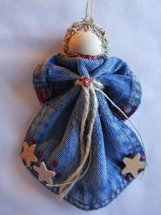 an angel ornament hanging from a string on a white background with red and blue stars