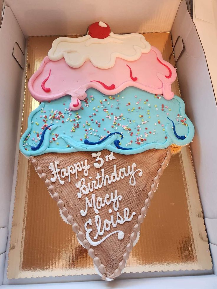 an ice cream cone shaped birthday cake in a box