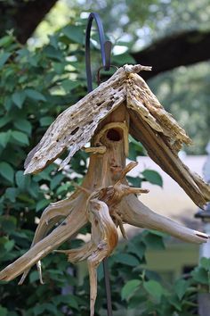 a bird house made out of drift wood