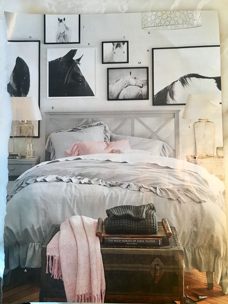 a bedroom with pictures on the wall above the bed and luggage under the bedspread