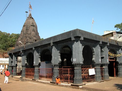 people are walking around in front of an old building that is being used as a temple