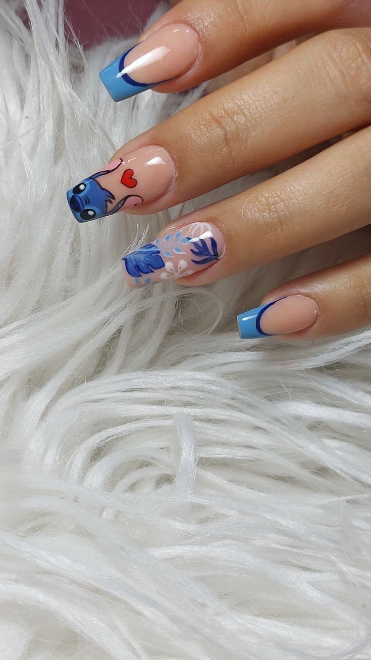 a woman's hand with blue and pink nail polish on it, next to white fur