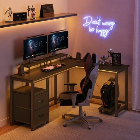 a computer desk with two monitors and a keyboard on it in front of a neon sign that reads don't want to be happy