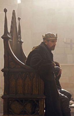 a man sitting on top of a wooden bench wearing a crown