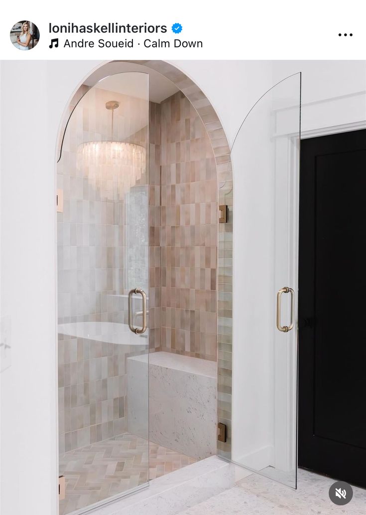 a bathroom with an arched glass shower door