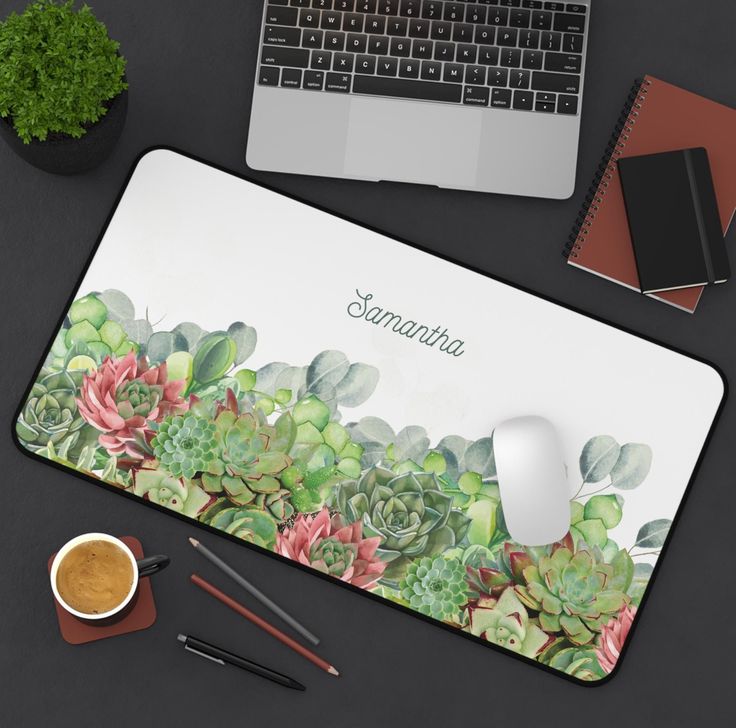 a mouse pad with succulents on it next to a cup of coffee