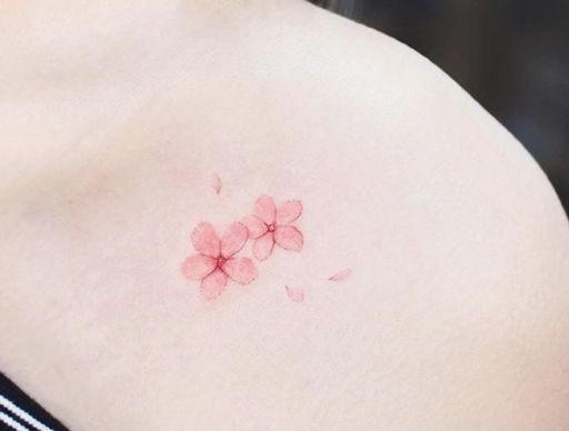 a woman's breast with pink flowers on it